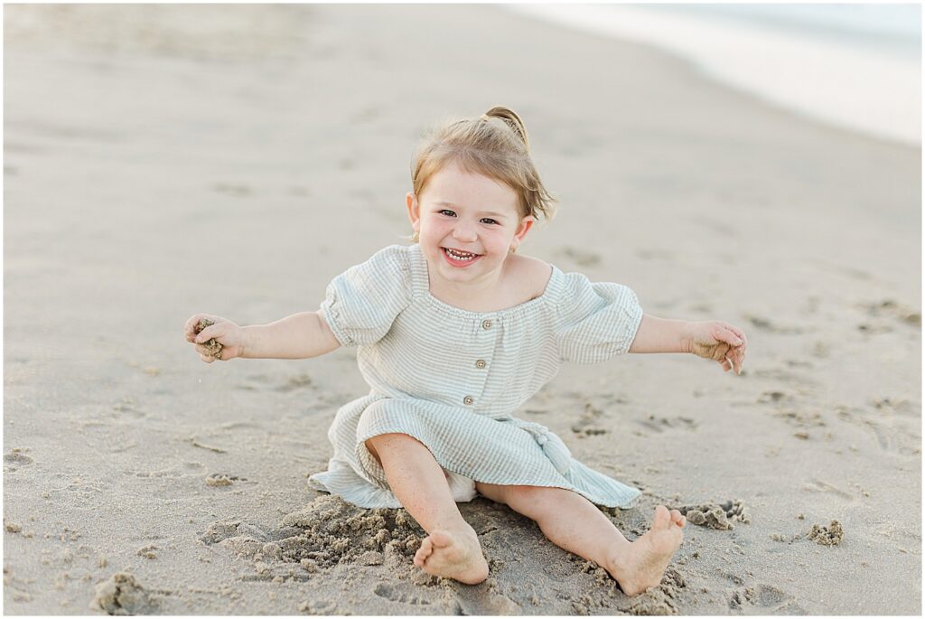 Little girl playing in the sand on the beach at cape henlopen state park