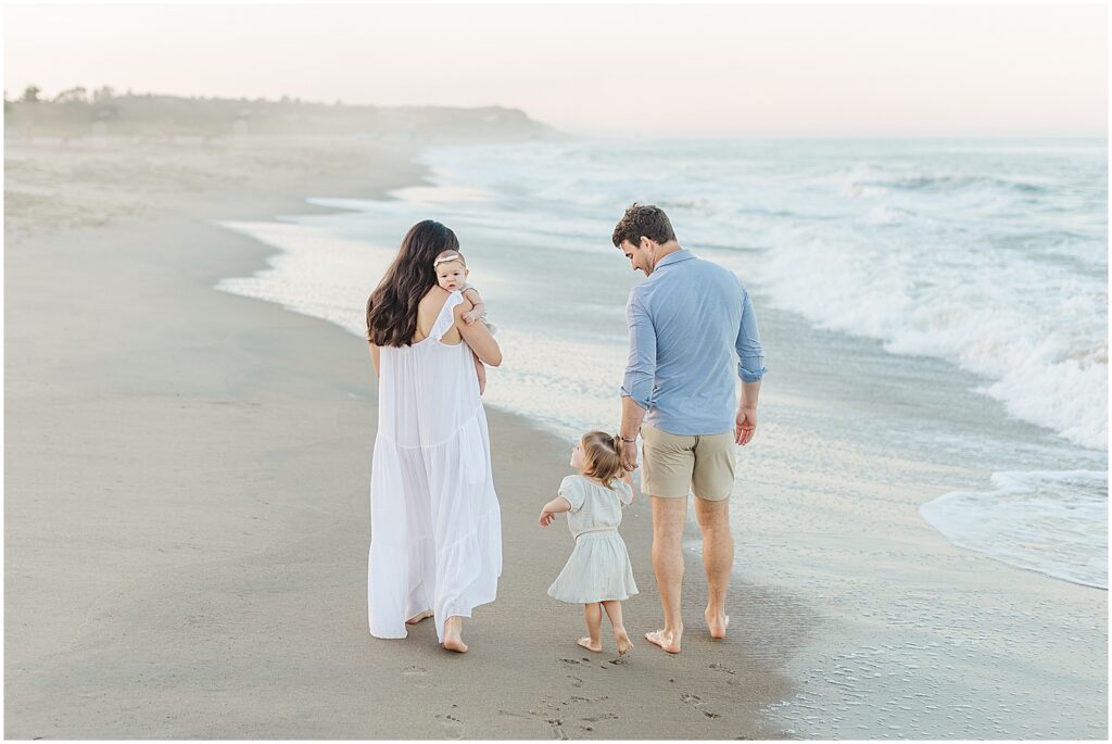 Family walking away on the beach at cape henlopen state park