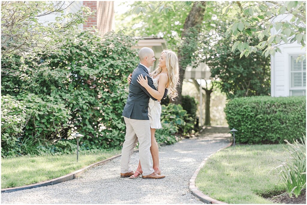 Couple having intimate, fun, playful moment on the grounds of the Inn at Perry Cabin in St. Micahels Maryland