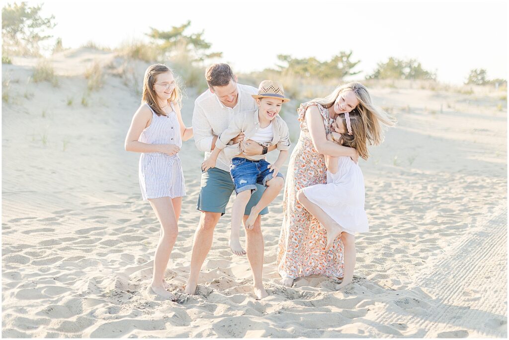 Family playing on the beach for their rehoboth beach family session