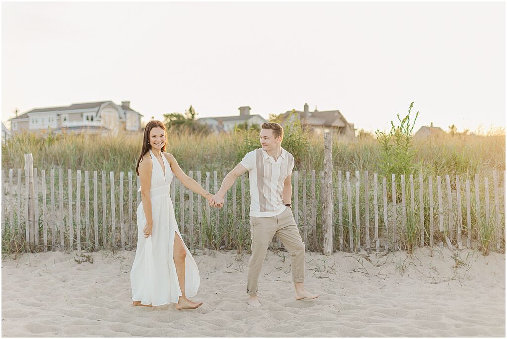 couple walking together on lewes beach, delaware.