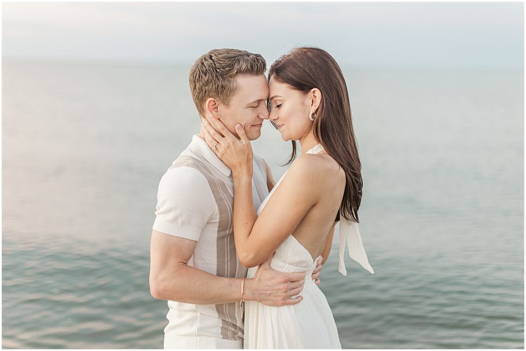 couple posing together for their delaware engagement photographer in lewes beach.